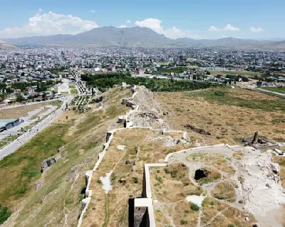 Aerial view along the fortified ridge of Van Castle, overlooking the city of Van and surrounding mountains in eastern Turkey.