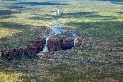 Aerial view of the King George River winding across the remote Kimberley plateau before plunging over the cliffs at King George Falls.