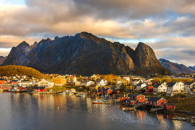 Fishing harbour and red rorbuer cabins in Sørvågen on Moskenesøya, Lofoten Islands, Norway.