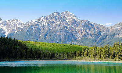 Patricia Lake with green forest, turquoise water, and snow-streaked mountain backdrop