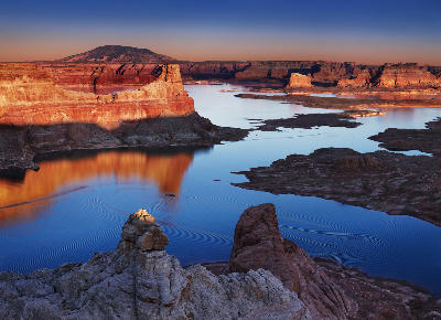Sunset view from Alstrom Point overlooking Lake Powell with sandstone cliffs in the Southwest United States.