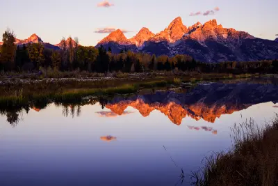 Autumn sunrise reflection of the Teton Range in the Snake River at Schwabacher Landing