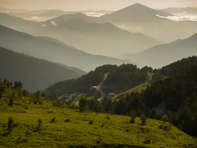 Green summer slopes of Saranoy Plateau overlooking layered ridges of the Zigana Mountains near Limni Lake in Gümüşhane, Turkey.