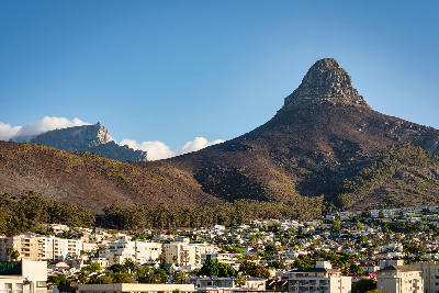 Lion’s Head mountain viewed from Sea Point district with residential buildings in foreground, Cape Town, South Africa.