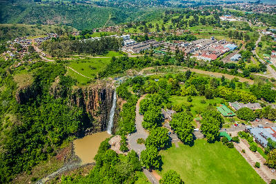 Aerial view of Howick Falls dropping into a forested gorge beside the town of Howick in the KwaZulu-Natal Midlands, South Africa.
