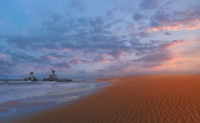 Shipwreck resting offshore beside coastal dunes and Atlantic surf on Namibia’s Skeleton Coast at sunset.