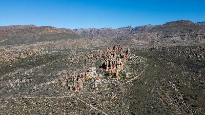 Aerial landscape of rugged sandstone rock formations, mountain ridges, and remote wilderness terrain in the Central Cederberg region of South Africa.