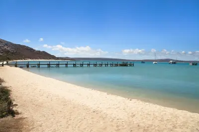 Jetty extending into the calm waters of Kraalbaai on Langebaan Lagoon in West Coast National Park, South Africa.