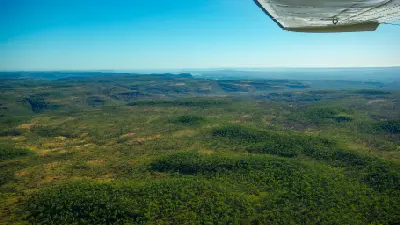 Vast woodland, rocky escarpments and rugged terrain stretch across the remote Mitchell Plateau, viewed from a light aircraft.