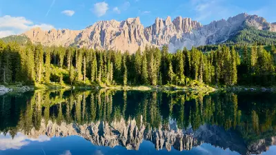 Lago di Carezza lake reflecting the Latemar mountains in the Dolomites, Italy.