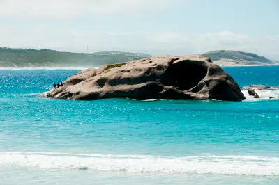 Large weathered granite outcrop surrounded by turquoise water at Twilight Beach near Esperance, Western Australia.