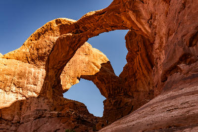 Double Arch sandstone formation from below with both arches visible in Arches National Park Utah