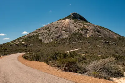 Road approaching Frenchman Peak and its granite summit in Cape Le Grand National Park, Western Australia.