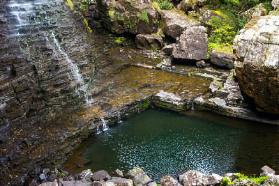 Rock pool and layered rock formations near Motitsi Waterfall on the forest floor of Graskop Gorge below the Graskop Gorge Lift.