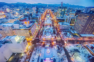 Wide city park with tree-lined lawns and seasonal displays running through central Sapporo at Odori Park, Hokkaido.
