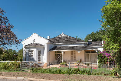 Historic 1914 house in Ladismith featuring traditional Karoo architecture and a landscaped garden in the Klein Karoo, Western Cape, South Africa.