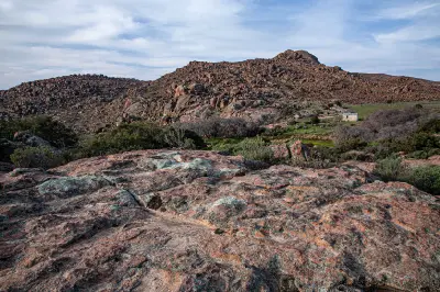 Traditional herders’ stockpost surrounded by granite hills and rugged landscapes in the Kamiesberg Mountains of Namaqualand, Northern Cape, South Africa.