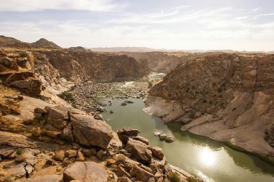 The Orange River flows between steep granite canyon walls below Ararat Viewpoint in Augrabies Falls National Park, South Africa.
