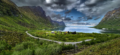 Bergsfjord seen from Bergsbotn viewpoint with winding road and houses in the foreground