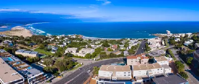 Aerial view of Plettenberg Bay showing Lookout Beach, Beacon Isle, coastal neighbourhoods and the Indian Ocean along the Garden Route.