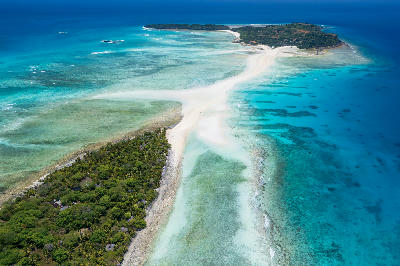 Aerial view of the Nosy Iranja Sandbar near Nosy Be in Madagascar showing white tidal sandbanks connecting tropical islands across turquoise reef lagoons