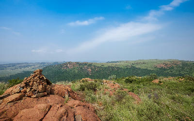 Rocky ridge and grassland landscape overlooking rolling hills in Suikerbosrand Nature Reserve south of Johannesburg.