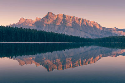 Mount Rundle reflected in calm water at Two Jack Lake during sunrise, Banff National Park, Alberta, Canada