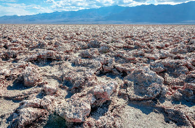 Detailed view of rough salt formations at Devils Golf Course in Death Valley National Park California showing jagged salt crust textures