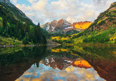 Maroon Bells mountain reflection in Maroon Lake at sunrise Colorado