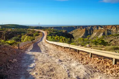 Unsealed road winding through the rugged landscape of Charles Knife Canyon.