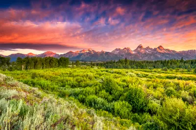 Sunrise over wetland landscape with the Teton Range in the distance, viewed from Blacktail Ponds Overlook, Grand Teton National Park, Wyoming.