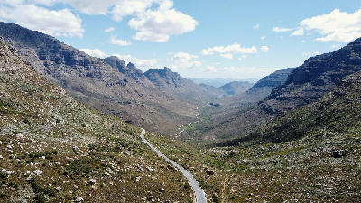 View from Uitkyk Pass with winding road descending through a sandstone valley in the Cederberg Mountains.