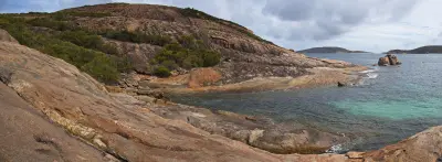 Granite shoreline and clear water at Little Hellfire Bay in Cape Le Grand National Park, Western Australia.