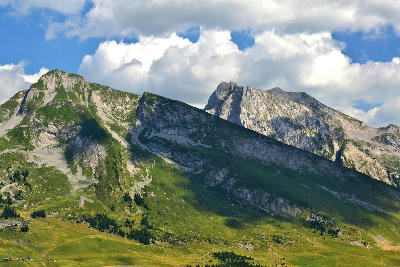 Aravis Mountain Range with limestone peaks and green alpine slopes above La Clusaz in the French Alps