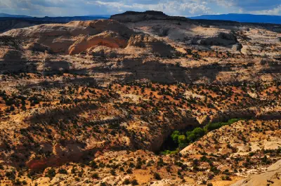 Sweeping view across the pale sandstone domes and rugged desert terrain of Calf Creek Canyon near the Lower Calf Creek Falls trail.