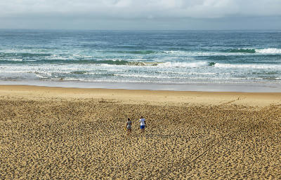 Visitors walking across Myoli Beach near Sedgefield on the Garden Route, South Africa