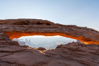 Mesa Arch with canyon landscape in soft early light Canyonlands National Park Utah