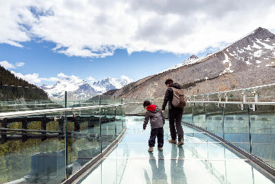 Visitors walking on the Columbia Icefield Skywalk overlooking glacier valleys in Jasper National Park, Alberta, Canada