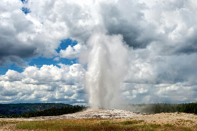 Old Faithful Geyser eruption Yellowstone National Park geothermal plume against cloudy sky Wyoming USA