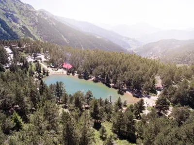 Aerial view of Limni Lake nestled among dense pine forest in the Zigana Mountains of Trabzon, Turkey.