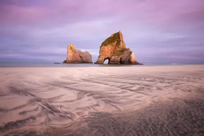 Archway Islands are offshore sea stacks visible from Wharariki Beach