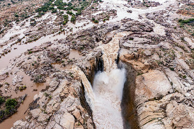 Aerial view of Augrabies Falls in flood cascading into a deep granite gorge in Augrabies Falls National Park.