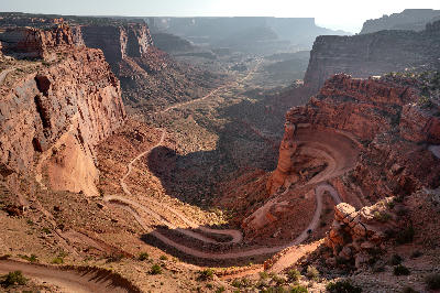 Shafer Trail switchbacks winding down steep canyon walls from Island in the Sky at Shafer Canyon Overlook in Canyonlands National Park Utah