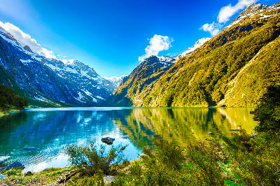 Lake Marian reflecting the peaks of the Darran Mountains in Fiordland National Park, South Island, New Zealand.