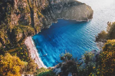High-angle view of Butterfly Valley, its secluded beach and turquoise Mediterranean water near Ölüdeniz, Türkiye.