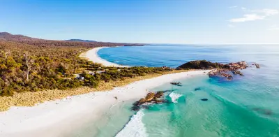 Aerial view of white-sand beaches, turquoise water and rocky coastline in the Bay of Fires, northeast Tasmania.