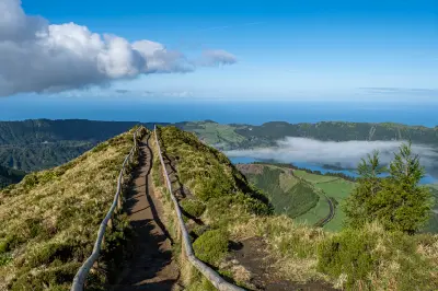 Footpath along the crater ridge at Miradouro da Boca do Inferno, overlooking the Sete Cidades caldera and Atlantic Ocean on São Miguel Island, Azores.