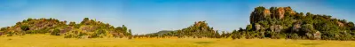Granite rock formations surrounded by open grassland at Moru Kopjes in Serengeti National Park, Tanzania.