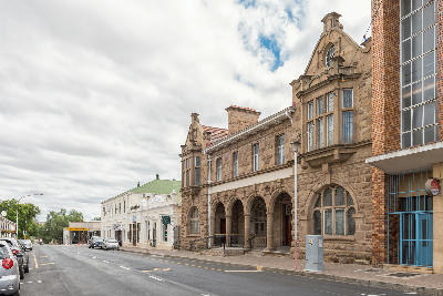 Historic sandstone buildings along a street in Oudtshoorn in the Little Karoo, Western Cape, South Africa