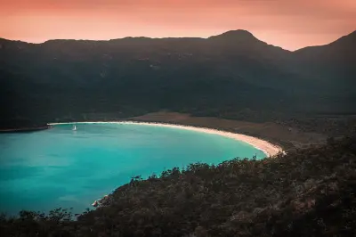 Turquoise waters and white sand of Wineglass Bay viewed from Wineglass Bay Lookout in Tasmania.